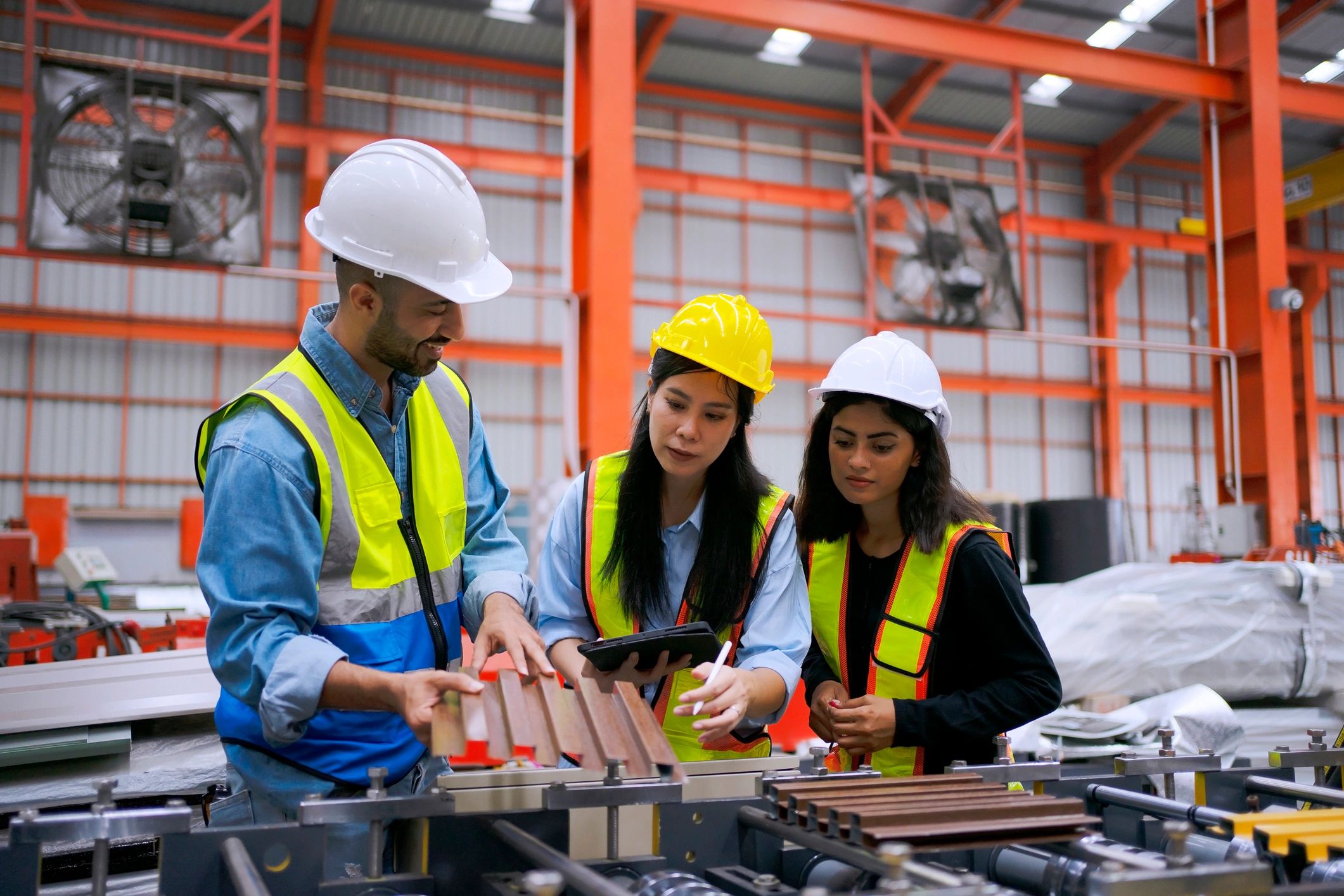 Blue collar worker work at metal sheet factory.